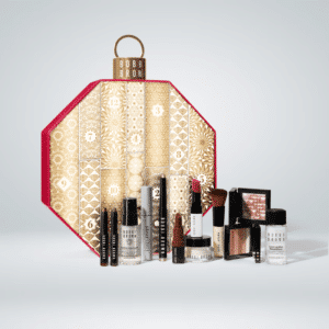 BOBBI BROWN 2023 advent calendar including 12 face and makeup products. It comes in an ornamental hexagon red and gold box, the perfect display this Chritmas