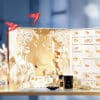 Guerlain Advent Calendar 2025 in gold and red design featuring 25 luxury mini perfumes, skincare, makeup and candles.