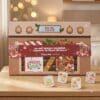 Disney Mystery Pin Advent Calendar 2026 oven box styled in a festive setting with four enamel pins