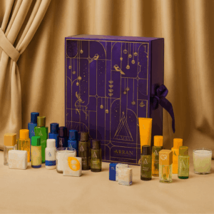 Arran Advent Calendar 2025 in festive red design with 25 luxury beauty treats and two exclusive seasonal scents.