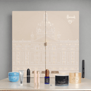 2025 Harrods beauty advent calendar is in a deep forest green casing with beautiful snowy white illustrations. The calendar has 25 drawers each filled with a beauty surprise.