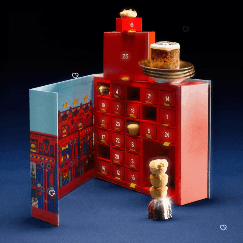 Selfridges Mini Mince Pie Advent Calendar 2025 contains 420g of festive mini mince pies, in a beautifully illustrated festive box, with a handy yellow ribbon for easy carrying