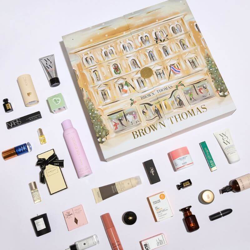 Brown Thomas Advent Calendar 2025 in festive red box with 25 luxury beauty treats from brands like NARS and Jo Malone.