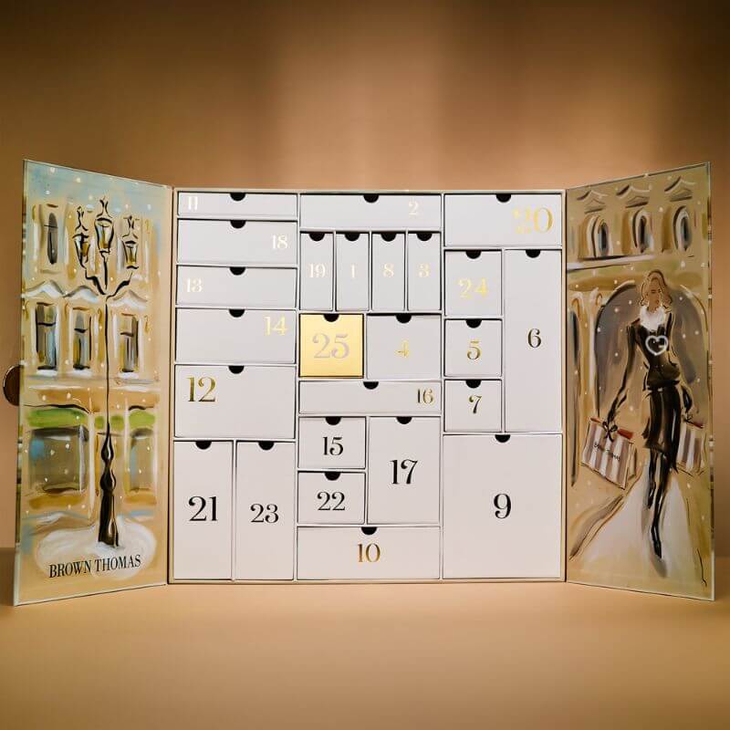 Brown Thomas Advent Calendar 2025 in festive red box with 25 luxury beauty treats from brands like NARS and Jo Malone.