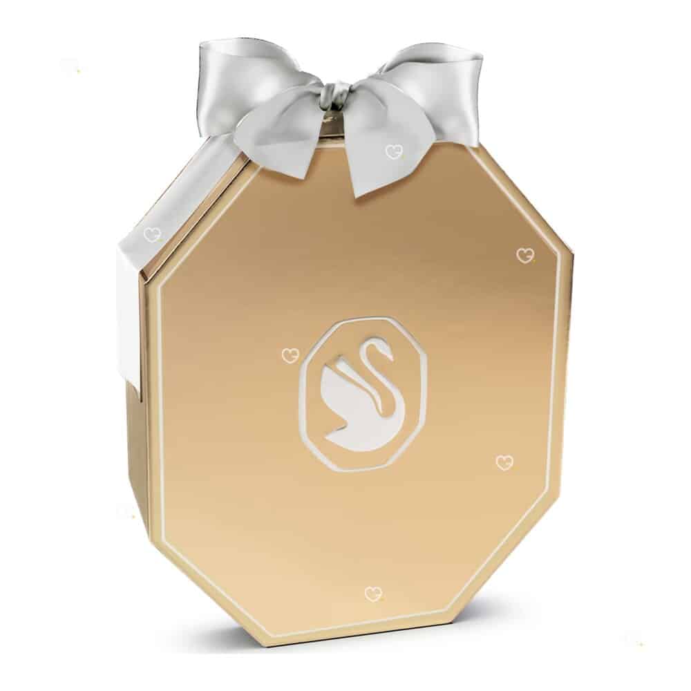 Swarovski Advent Calendar 2026, a luxury advent calendar in a champagne gold-tone octagonal box with a white bow, shown closed