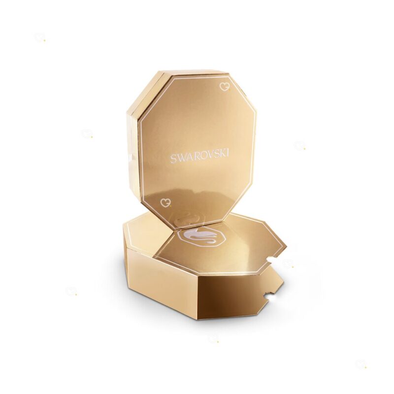 Open empty Swarovski Advent Calendar 2026 champagne gold-tone case showing the Swarovski swan inside