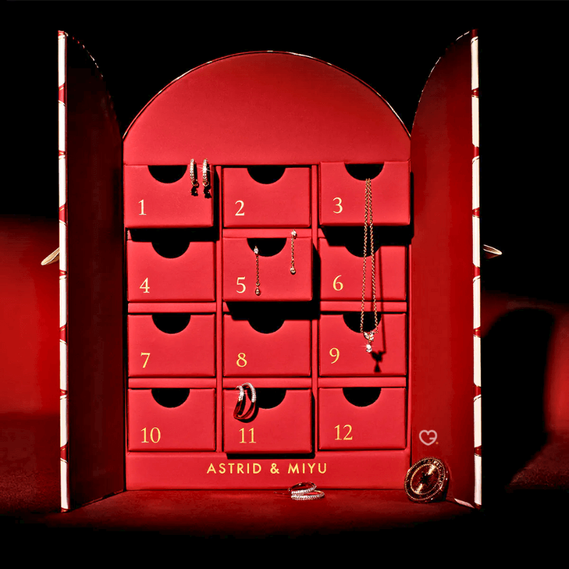 Astrid & Miyu - 12 day Advent Calendar 2025 in gold featuring 11 gold jewels and £50 voucher, perfect for style-conscious women.