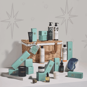 Cowshed Advent Calendar 2025 in a wicker hamper with 24 beauty treats from candles to lotions for festive self-care.