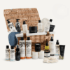 Cowshed Advent Calendar 2025 in a wicker hamper with 24 beauty treats from candles to lotions for festive self-care.