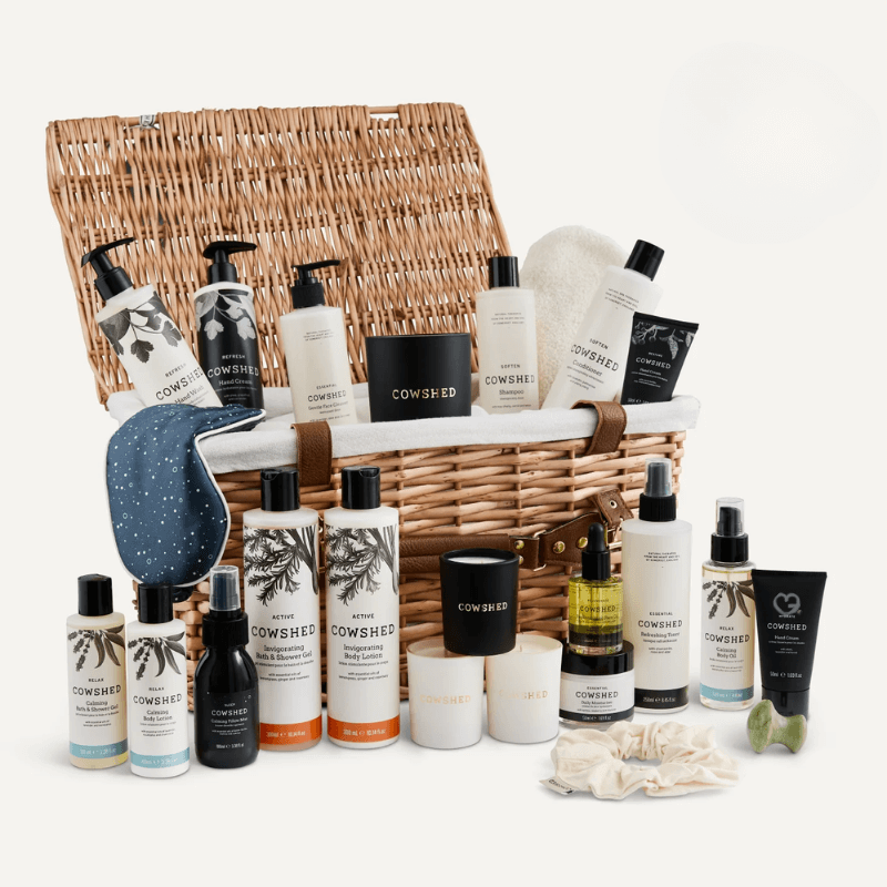 Cowshed Advent Calendar 2025 in a wicker hamper with 24 beauty treats from candles to lotions for festive self-care.