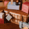 Cowshed Advent Calendar 2025 in a wicker hamper with 24 beauty treats from candles to lotions for festive self-care.