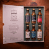 Whisky Tour of Scotland Advent Calendar 2025 is a masterfully designed set, featuring five linen-bound and gold-foiled books within a handmade, engraved wooden bookcase.