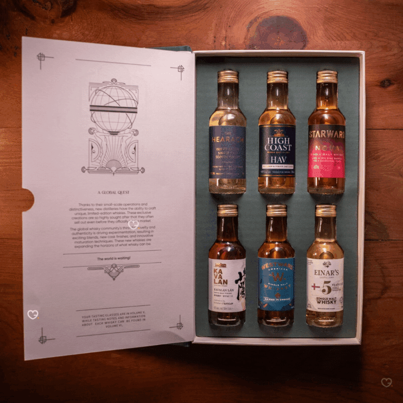 Whisky Tour of Scotland Advent Calendar 2025 is a masterfully designed set, featuring five linen-bound and gold-foiled books within a handmade, engraved wooden bookcase.
