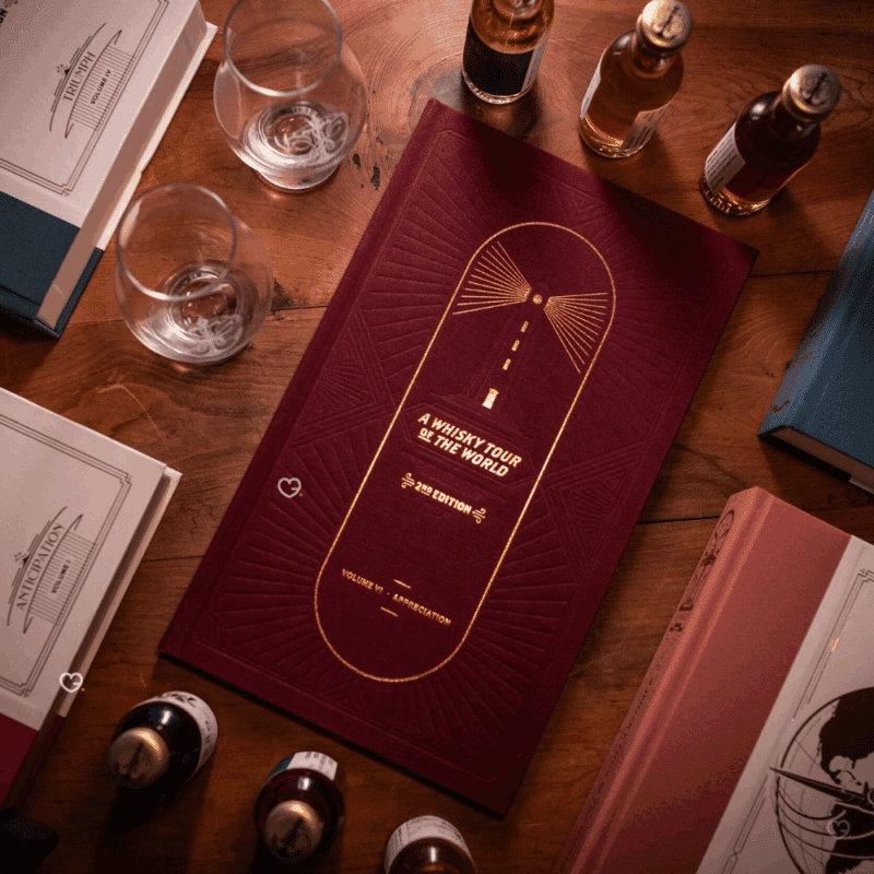 Whisky Tour of Scotland Advent Calendar 2025 is a masterfully designed set, featuring five linen-bound and gold-foiled books within a handmade, engraved wooden bookcase.