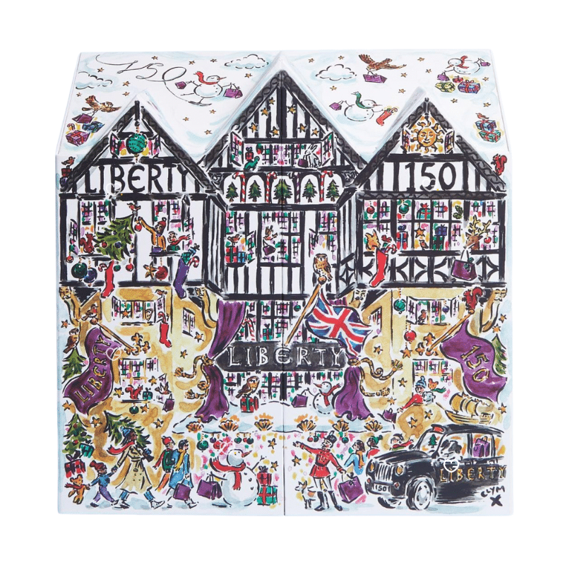 Luxurious Liberty London Advent Calendar 2025, illustrated in the shape of the iconic Tudor storefront, featuring high-end skincare, makeup, and fragrance products from brands like Le Labo, Augustinus Bader, and Sisley.