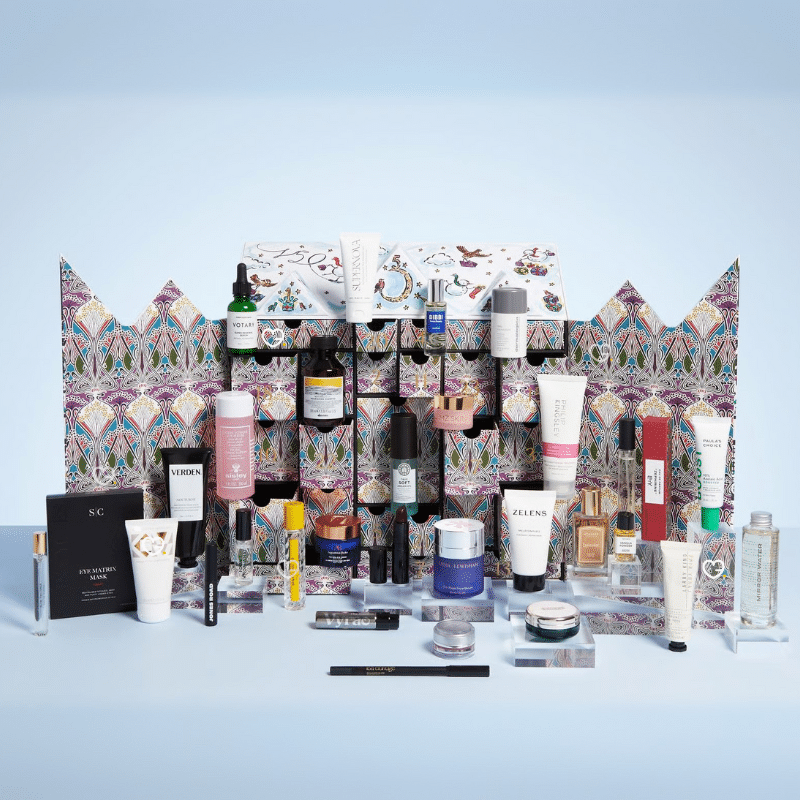 Liberty London beauty Advent Calendar 2025, illustrated in the shape of the iconic Tudor storefront, featuring high-end skincare, makeup, and fragrance products from brands like Le Labo, Augustinus Bader, and Sisley.