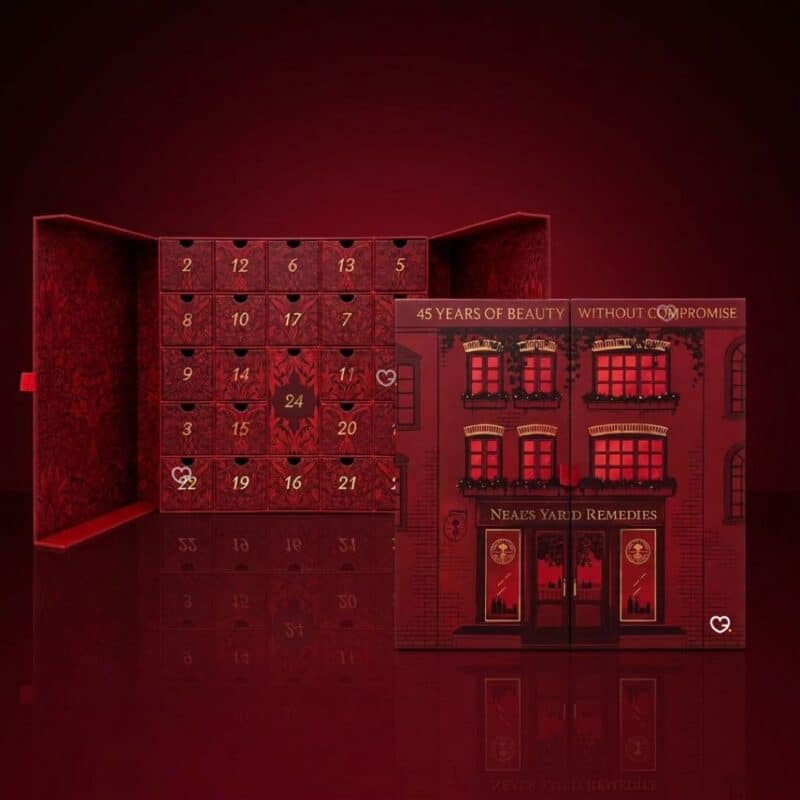 Neal's Yard Remedies 2026 advent calendar open, showing 24 numbered drawers and Covent Garden flagship illustration, red background