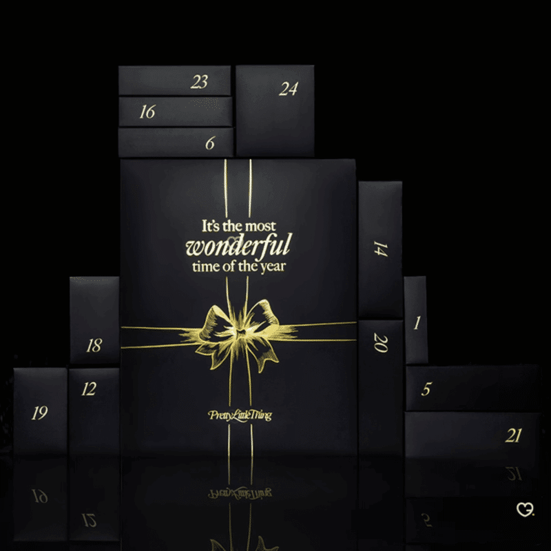 Prettylittlething Advent Calendar 2025 in pink festive box with 24 beauty treats including skincare, makeup and haircare.