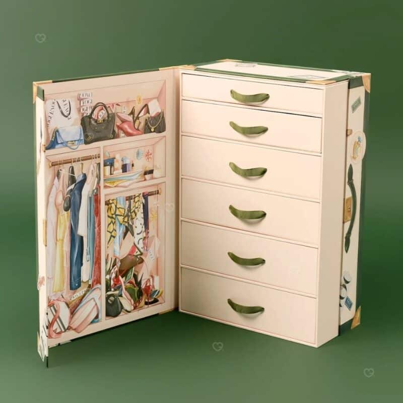 Vogue Festive Calendar 2026 open trunk with 25 numbered drawers and illustrated dressing-room lining