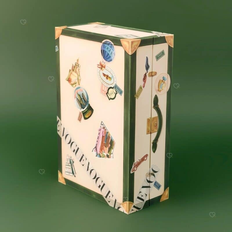 Vogue Festive Calendar 2026 Art Deco trunk closed, three-quarter angle showing the VOGUE ribbon on the lid