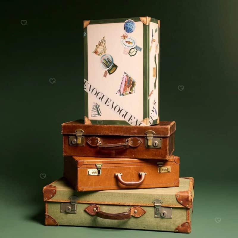 Vogue Festive Calendar 2026 trunk displayed on vintage travel cases with festive styling