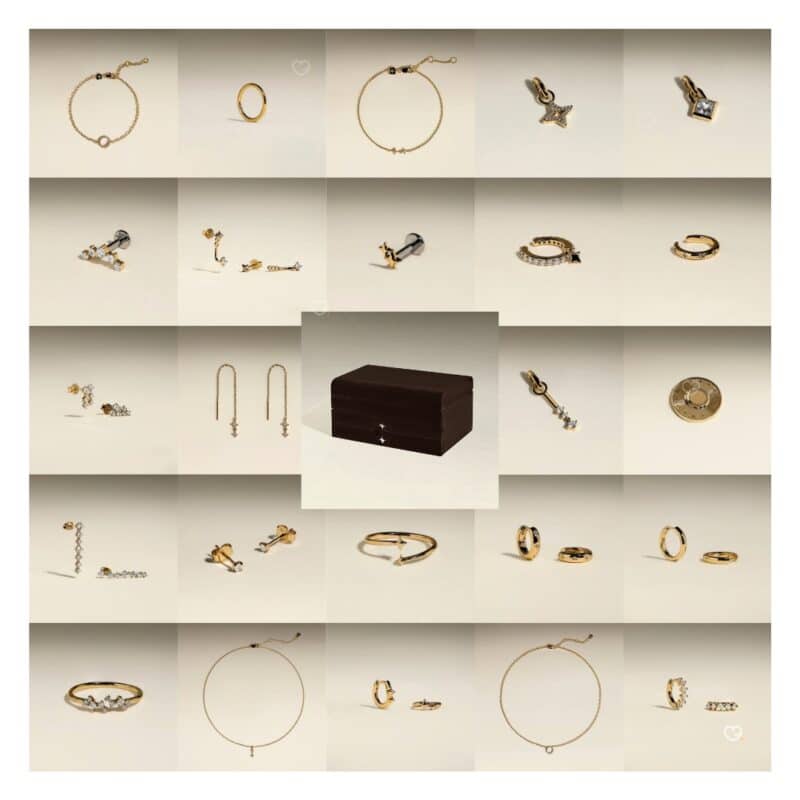 All 23 gold jewellery pieces from the Astrid & Miyu 2026 advent calendar laid out with the box