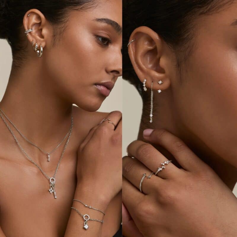 Model showing the gold and silver versions of the Astrid & Miyu 2026 advent calendar jewellery