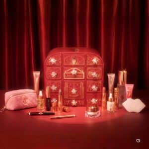 Charlotte Tilbury Hollywood Beauty Wonderland Advent Calendar 2026 with its full line-up of makeup and skincare in front of the red keepsake box