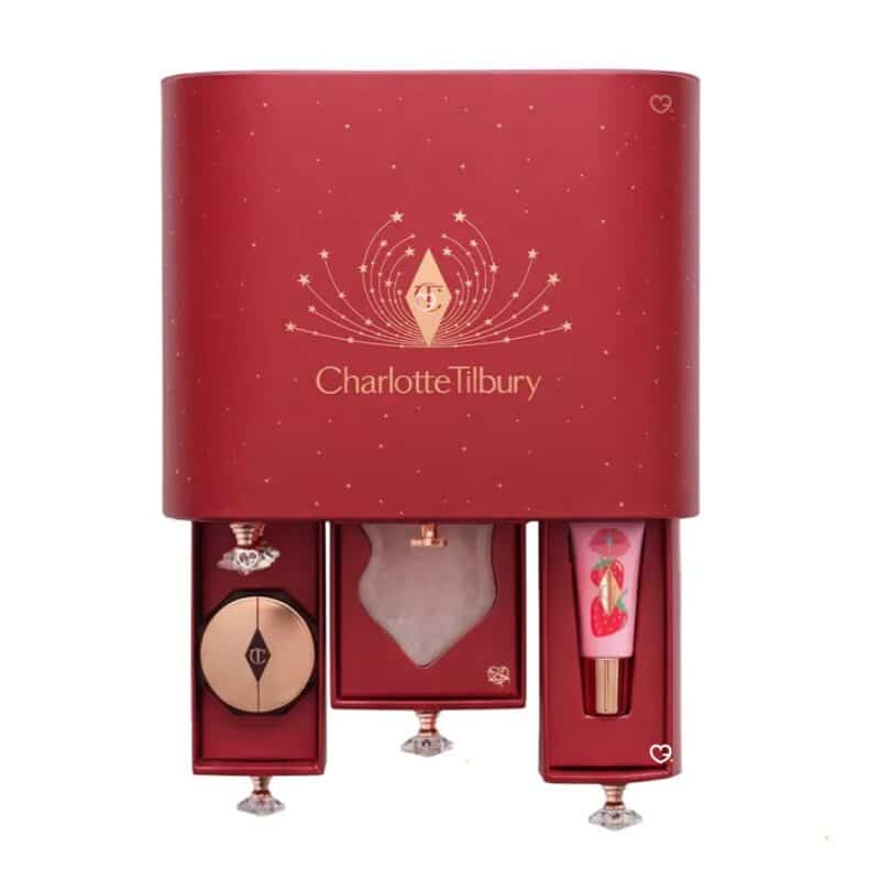 Open drawers of the Charlotte Tilbury Advent Calendar 2026 showing the white quartz gua sha and the Unreal Lips Nectar Oil
