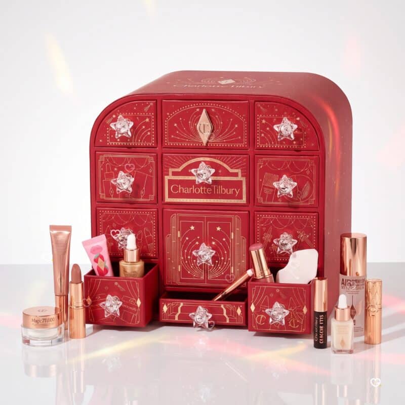 Charlotte Tilbury Advent Calendar 2026 open with full-size and travel-size products on a white background