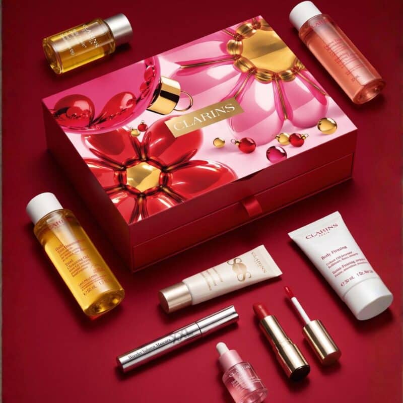Clarins Advent Calendar 2026 with Tonic body oil, cleanser and make-up on red