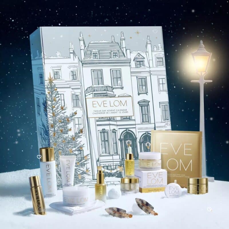 Eve Lom luxury skincare advent calendar 2026 with products beside a lamp-lit snowy scene