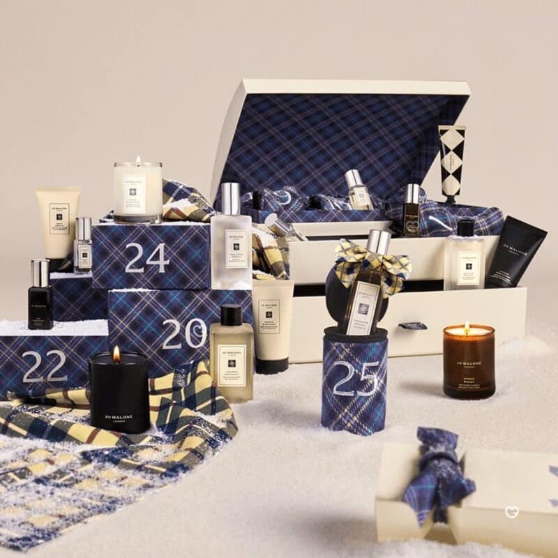 Full spread of the Jo Malone Advent Calendar 2026 with numbered tartan stockings