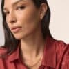 Woman wearing gold hoop earrings and a chain necklace from the Missoma Advent Calendar 2026, a luxury jewellery advent calendar