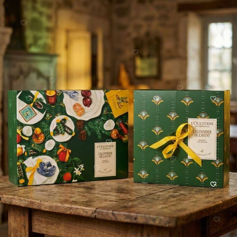 L'Occitane skincare Advent Calendar 2026 closed green box in a festive Christmas setting