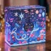 Space NK Advent Calendar 2026 double-door box styled on a wooden table with festive lights