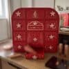 Charlotte Tilbury Advent Calendar 2026 on a desk with one of its 12 drawers pulled open