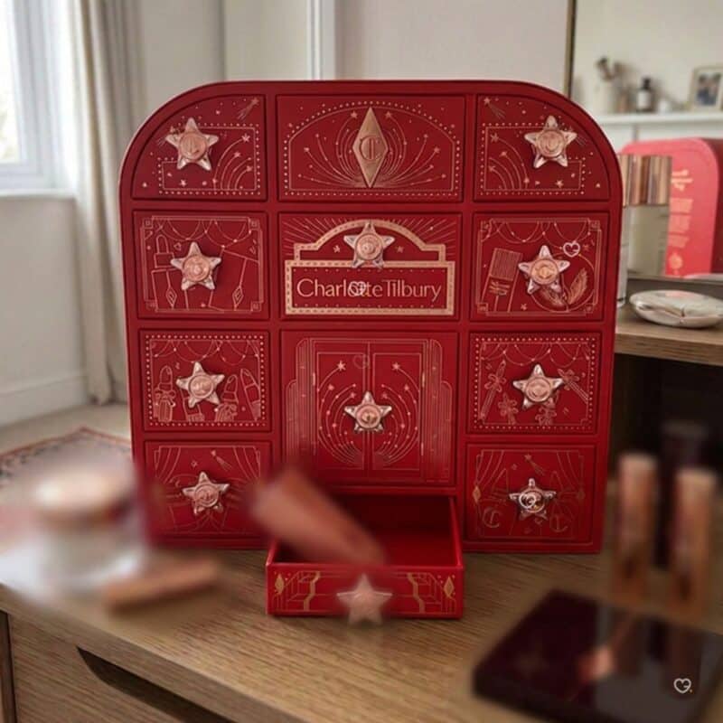 Charlotte Tilbury Advent Calendar 2026 on a desk with one of its 12 drawers pulled open