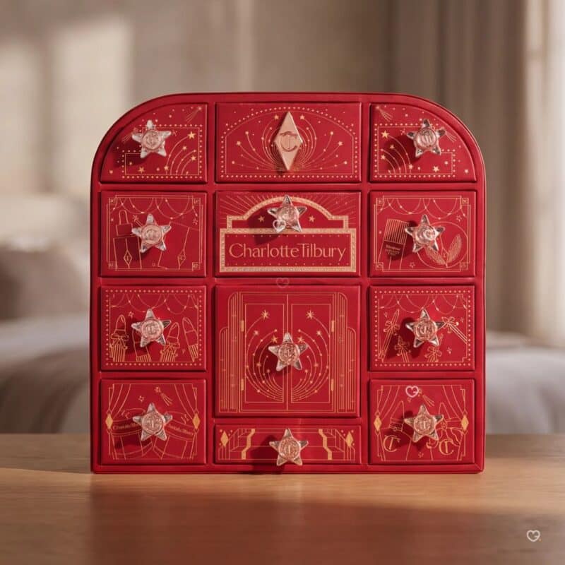 Charlotte Tilbury Advent Calendar 2026, red 12-door beauty chest on a wooden table