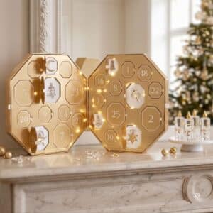 Swarovski Advent Calendar 2026 crystal advent calendar styled beside a lit Christmas tree, opened with crystal candles, the Kris Bear and ornaments displayed in front