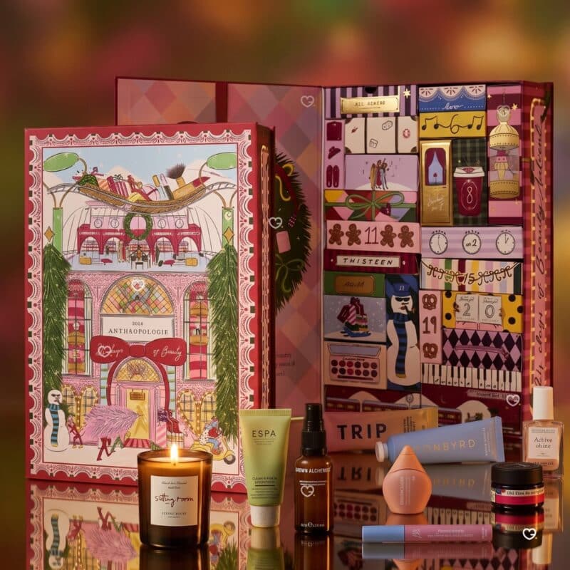 Anthropologie beauty advent calendar 2026 styled on a burgundy background with its skincare and haircare products