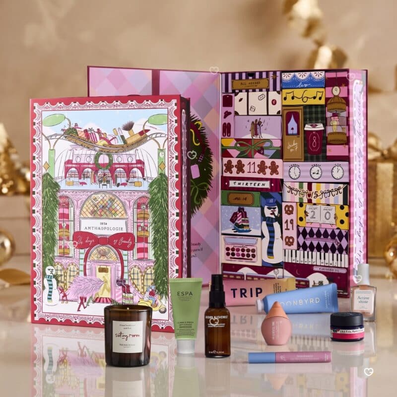 Anthropologie 2026 beauty advent calendar with its contents on a cream and gold festive backdrop