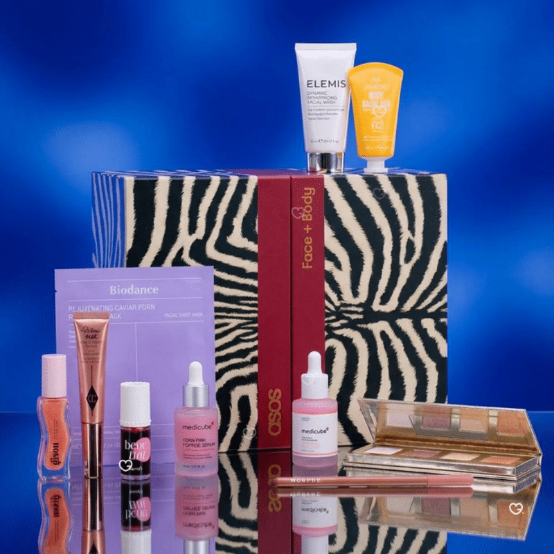 ASOS Advent Calendar 2026 zebra box surrounded by skincare and makeup products including Charlotte Tilbury and Elemis