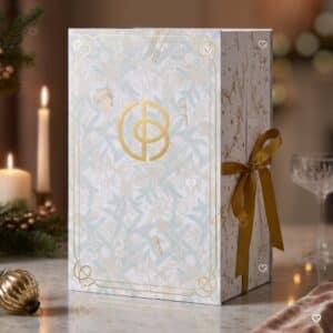 Cult Beauty Advent Calendar 2026 box styled in a Christmas scene with gold ribbon