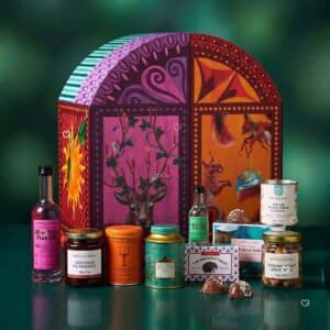 Fortnum's Feasting Advent Calendar 2026 box with gourmet food and drink arranged in front