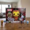 Funko Pocket POP Marvel advent calendar 2026 open with Iron Man, Captain America snowman, Black Panther gingerbread and Spider-Man frost figures on wooden table