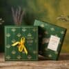 L Occitane Luxury Advent Calendar 2026 packaging, front ribbon and peacock-motif back, beauty advent calendar