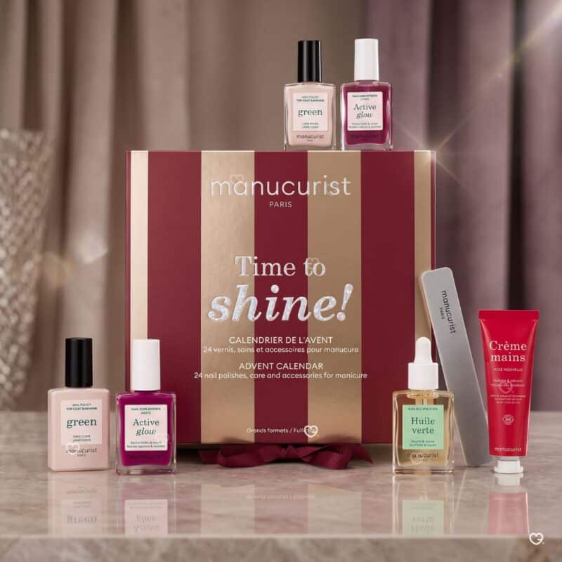 Manucurist nail advent calendar 2026 Active Glow, top coat and Green oil on a marble surface