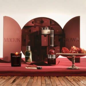 Molton Brown Advent Calendar 2026 open showing numbered drawers, candle, bath gel and festive treats