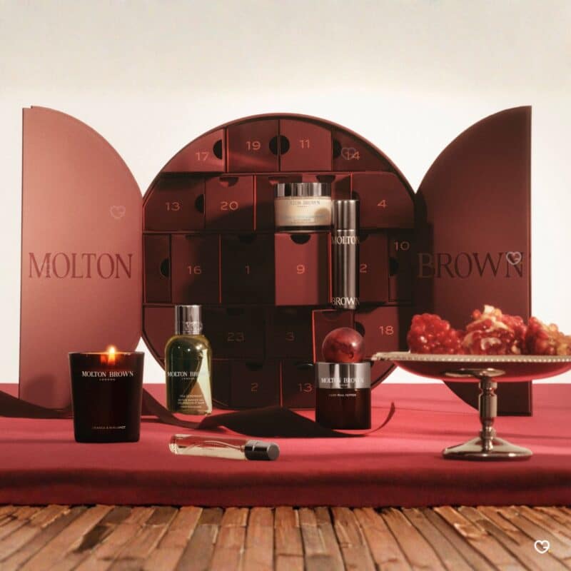 Molton Brown Advent Calendar 2026 open showing numbered drawers, candle, bath gel and festive treats